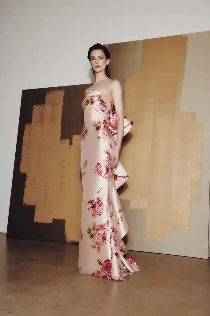 model is wearing a strapless light pink floral mothers dress
